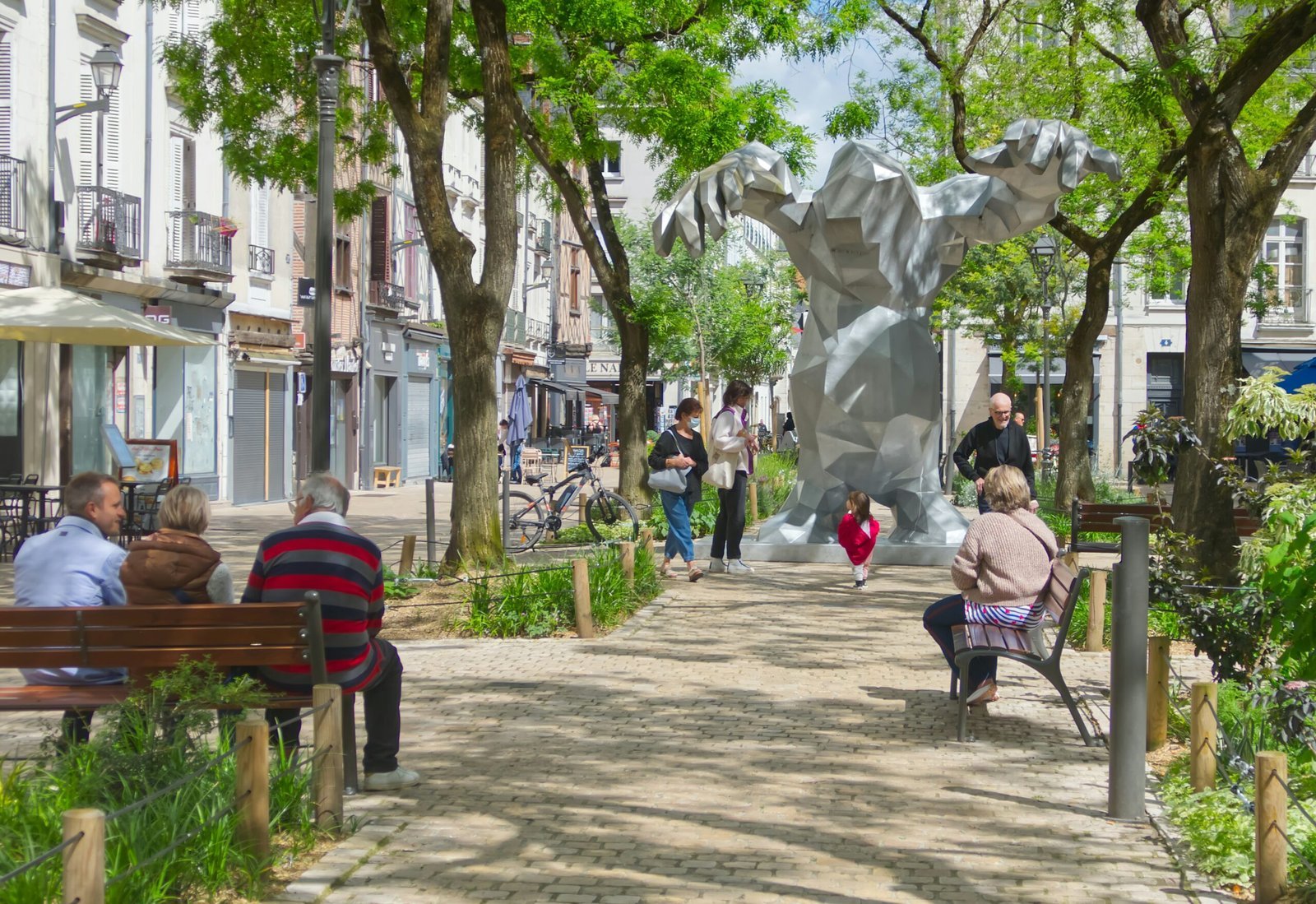 A group of people sitting on a bench in a park